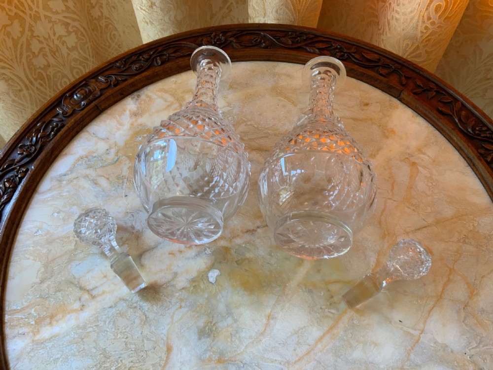 A clear Georgian cut glass decanter featuring three neck rings, a diamond cut band, and a matching mushroom-shaped faceted stopper. View VI