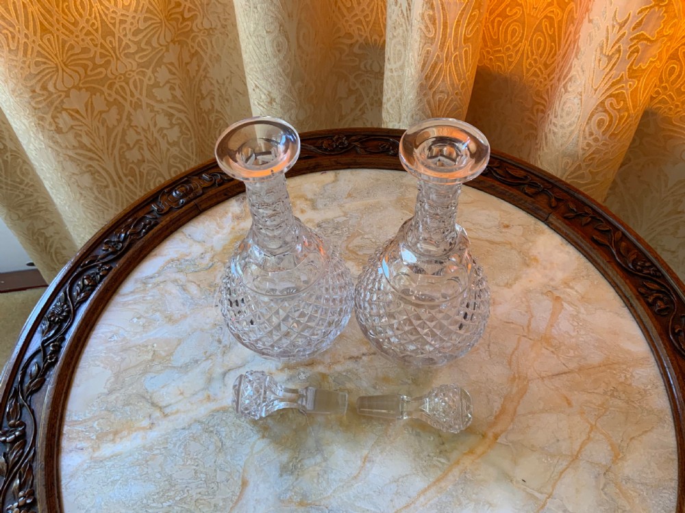 A clear Georgian cut glass decanter featuring three neck rings, a diamond cut band, and a matching mushroom-shaped faceted stopper. View VII