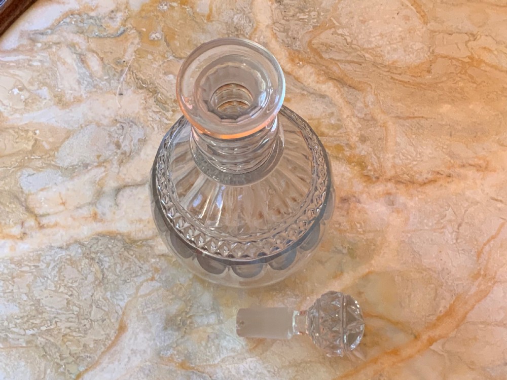 A clear Georgian cut glass decanter featuring three neck rings, a diamond cut band, and a matching mushroom-shaped faceted stopper. View XI
