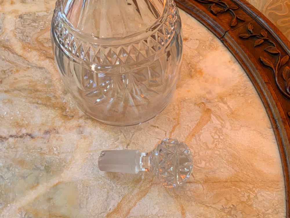 A clear Georgian cut glass decanter featuring three neck rings, a diamond cut band, and a matching mushroom-shaped faceted stopper. View XII