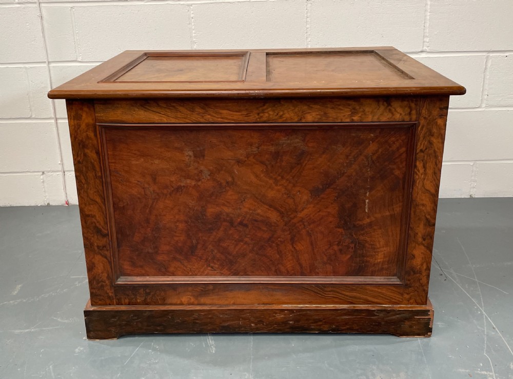 A low antique walnut chest of drawers featuring three full-width drawers with decorative cast metal handles and a panelled top. View II