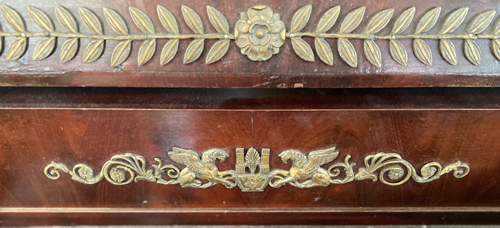 A French Empire style dark mahogany dressing table featuring gilded bronze ormolu mounts, a pediment mirror frame, small side drawers, and a lower shelf. View VII