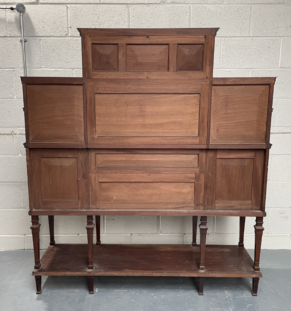 An Aesthetic Movement dark rosewood side cabinet featuring intricate arabesque marquetry inlay panels, a tiered superstructure with central mirror, and turned legs with an open lower shelf. View II