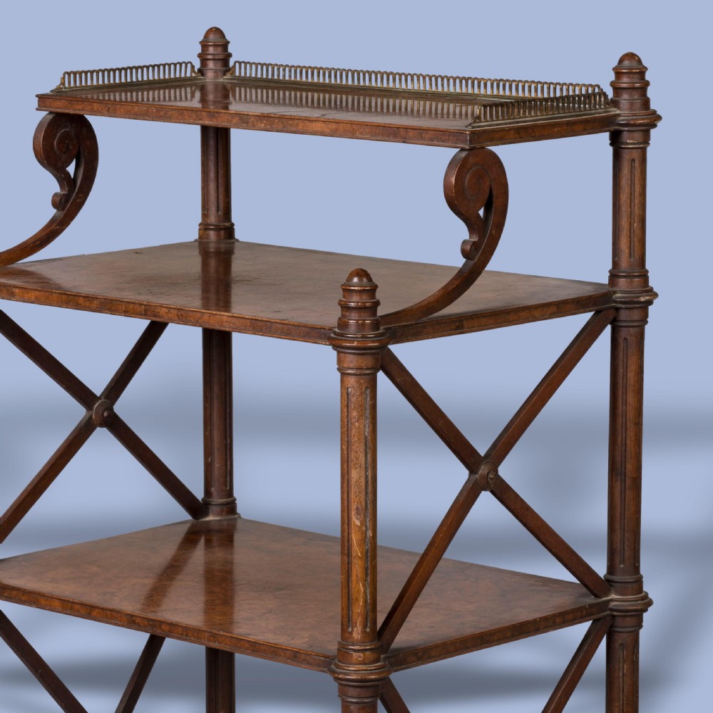 An antique walnut tiered whatnot with X-frame sides, turned columns, brass castors, and a small top shelf with a brass gallery rail. View III