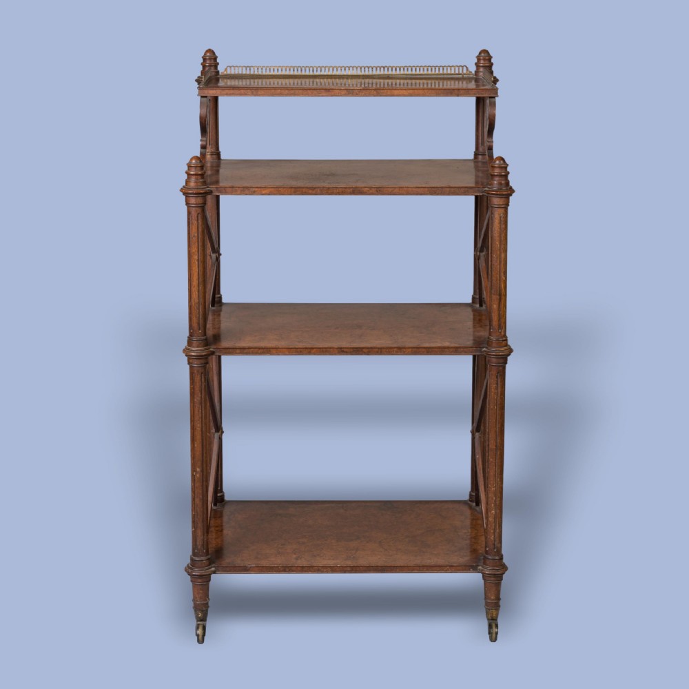 An antique walnut tiered whatnot with X-frame sides, turned columns, brass castors, and a small top shelf with a brass gallery rail. View IV