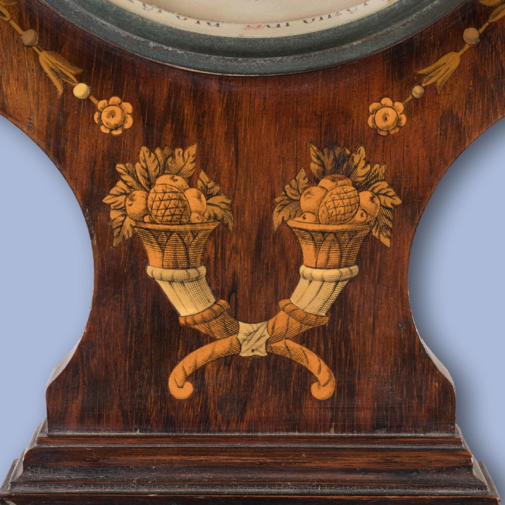 A Neoclassical mahogany wall barometer featuring detailed marquetry inlay of classical figures, a thermometer tube, and a circular weather dial. View III