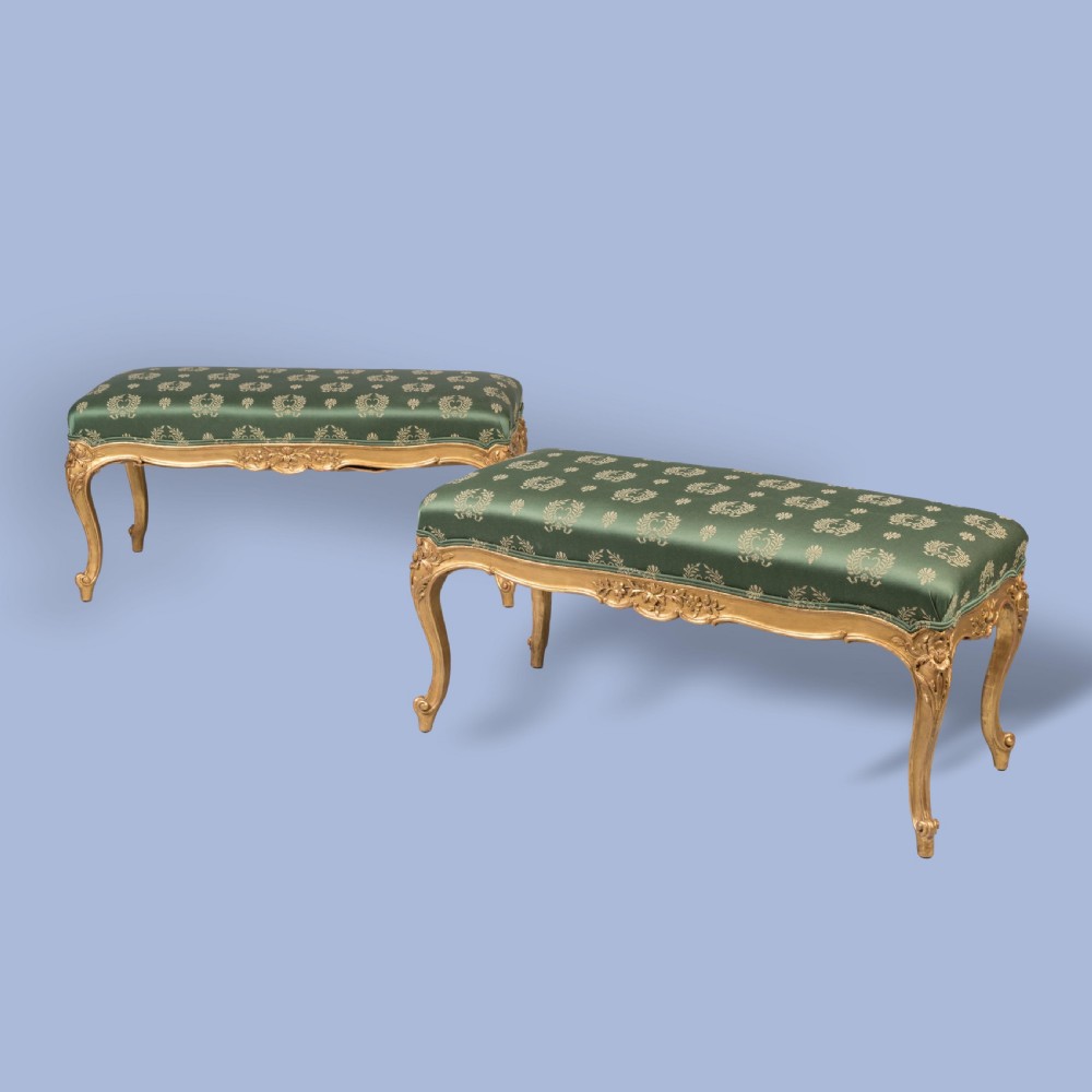 A FINE PAIR OF GILTWOOD FOOTSTOOLS IN THE LOUIS XV MANNER