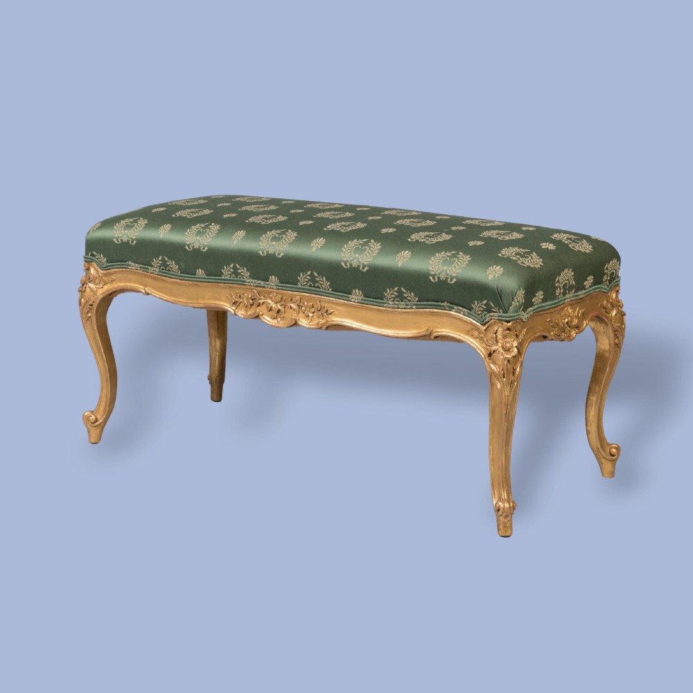 A FINE PAIR OF GILTWOOD FOOTSTOOLS IN THE LOUIS XV MANNER View II
