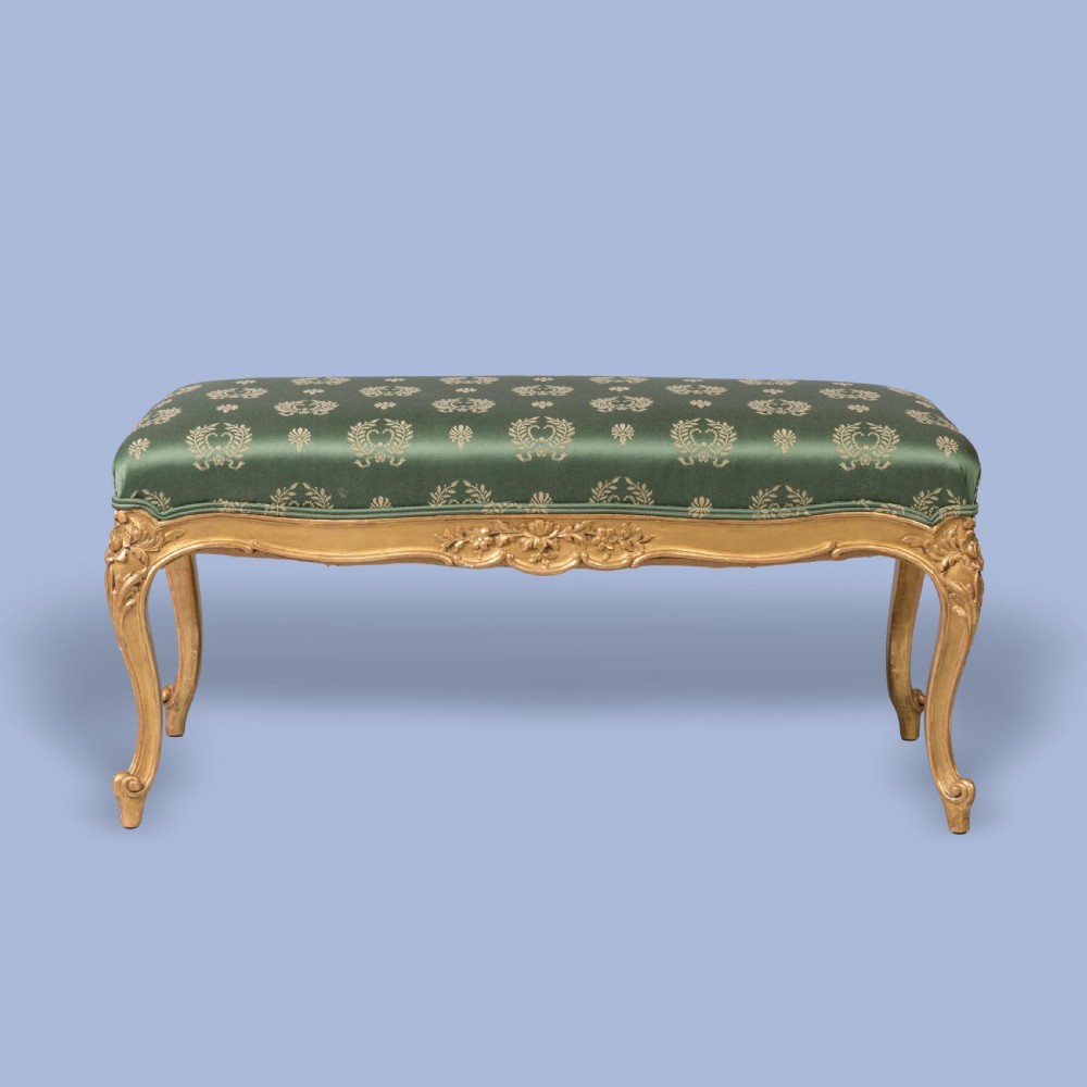 A FINE PAIR OF GILTWOOD FOOTSTOOLS IN THE LOUIS XV MANNER View III