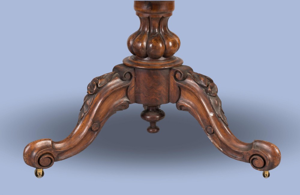 A circular Victorian walnut centre table featuring elaborate floral marquetry inlay set on a carved tripod base. View III