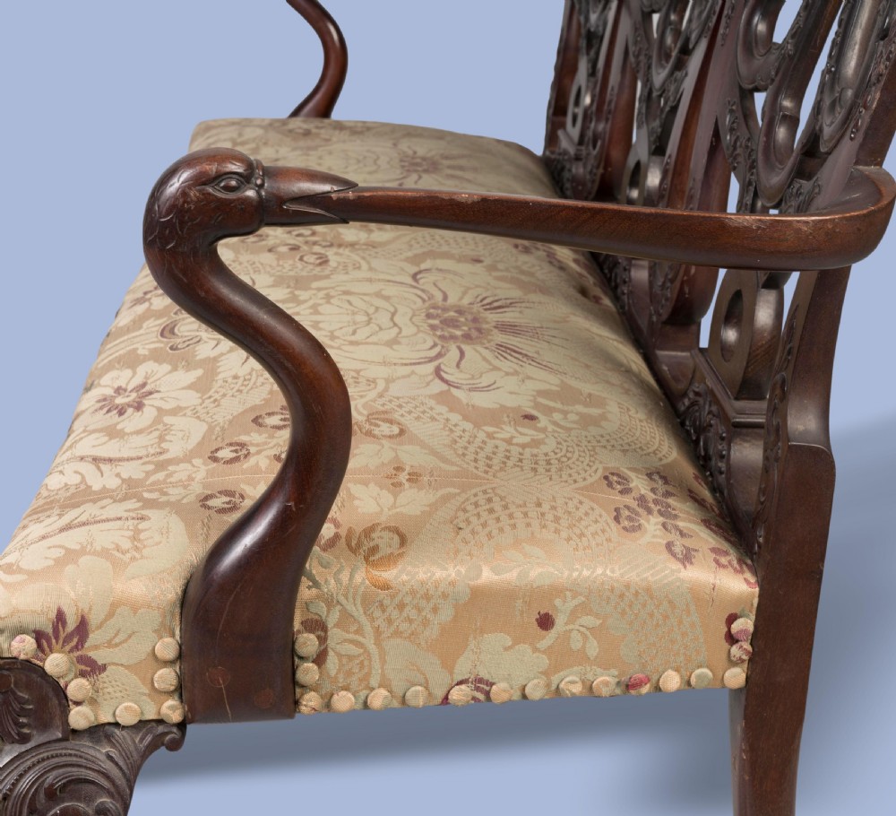 A George II style triple-back carved mahogany settee featuring intricate pierced splats, floral fabric upholstery, and cabriole legs with ball-and-claw feet. View III