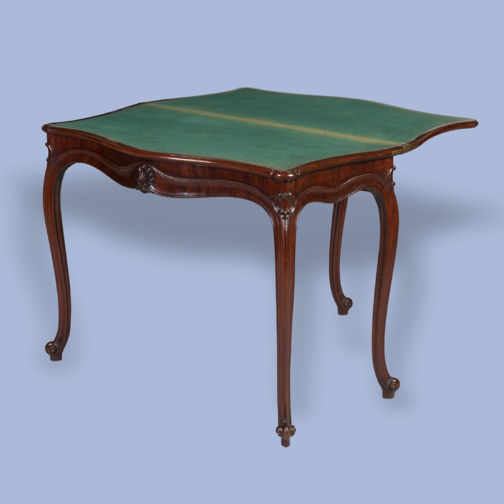 A Georgian mahogany fold-over card table featuring slender cabriole legs, a carved shell central apron motif, and a serpentine front. View IV