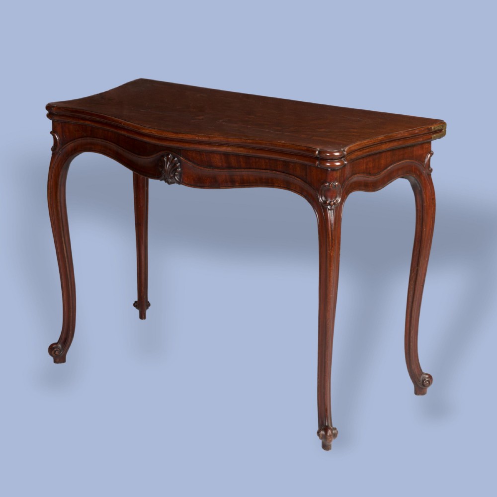 A Georgian mahogany fold-over card table featuring slender cabriole legs, a carved shell central apron motif, and a serpentine front. View VI