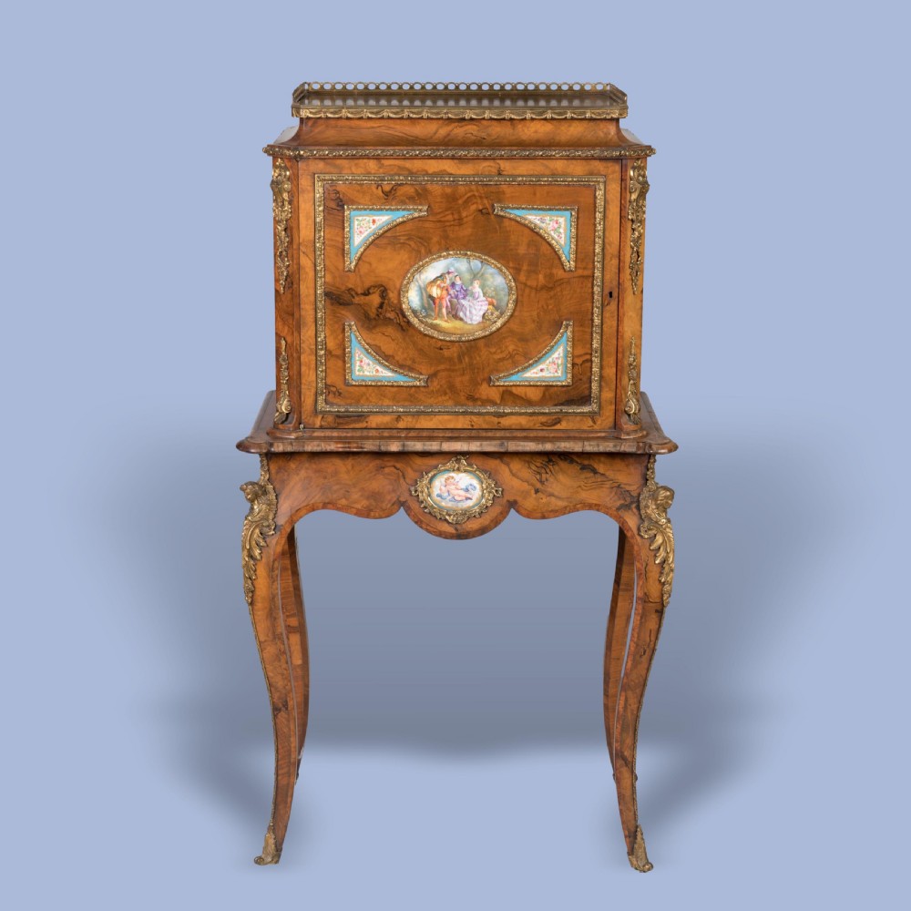 A burr walnut cabinet on stand featuring cabriole legs, gilt-bronze mounts, and hand-painted porcelain medallions in the Louis XV manner. View II