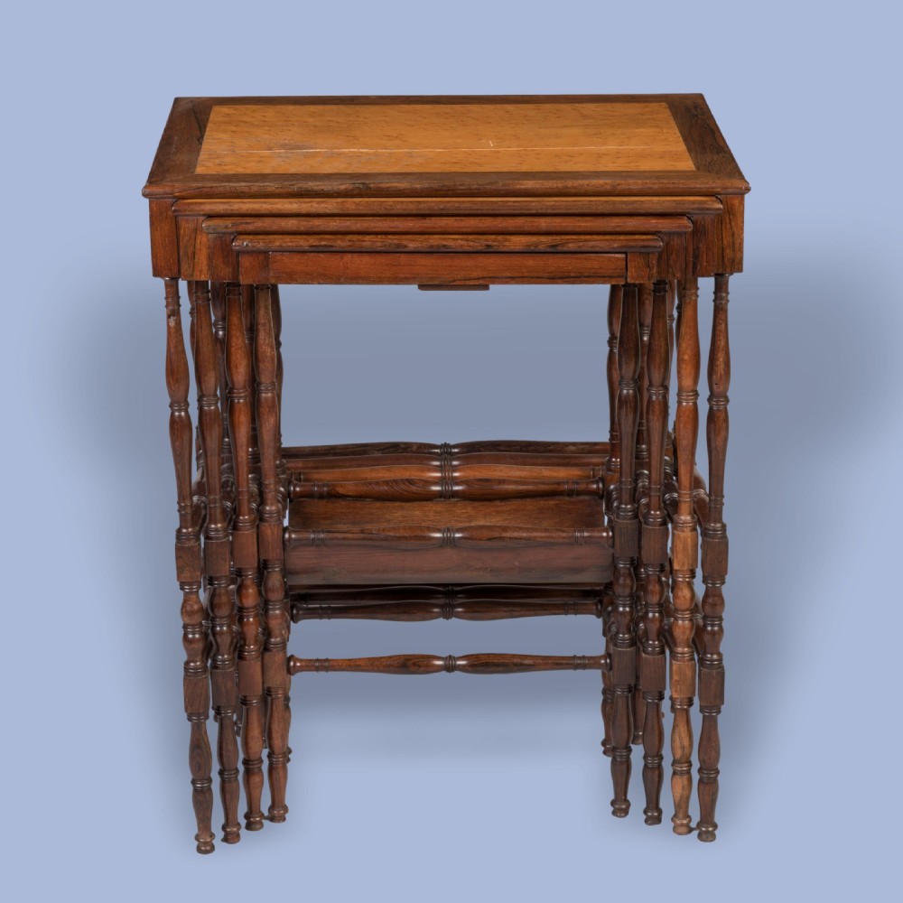 A set of four graduating brown rosewood quartetto tables featuring spindled legs and an inlaid chessboard top nested together. View II