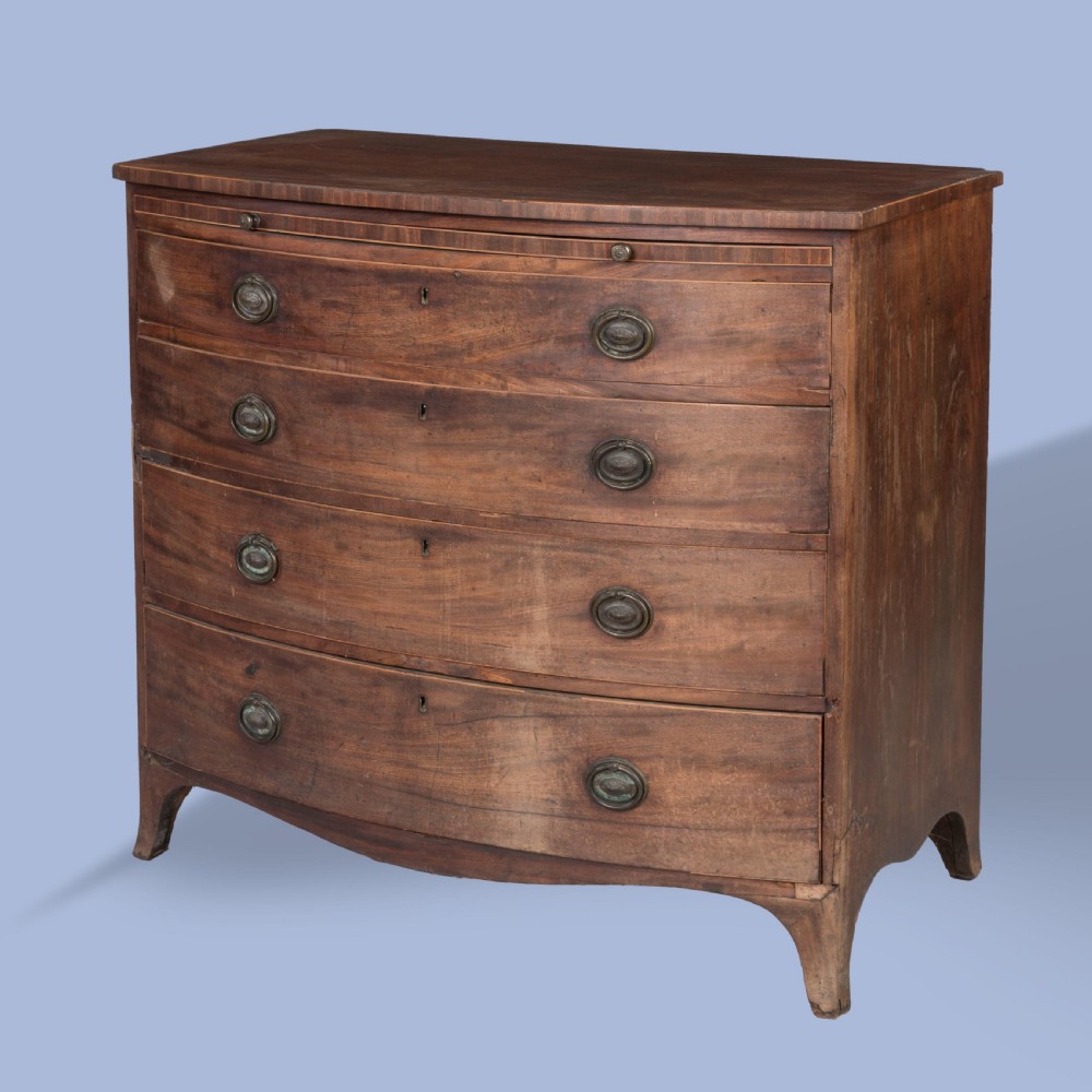 A George III mahogany bowfront chest featuring four graduated drawers with brass oval handles and splayed bracket feet.