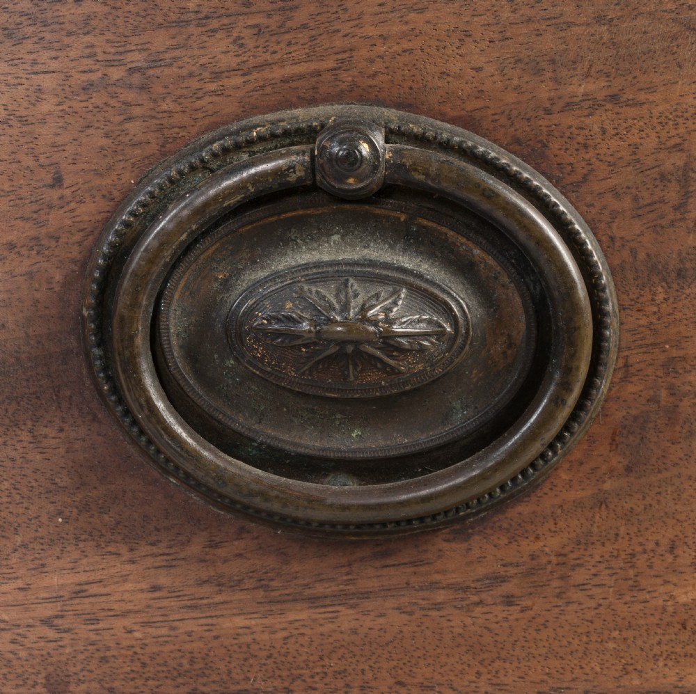 A George III mahogany bowfront chest featuring four graduated drawers with brass oval handles and splayed bracket feet. View V