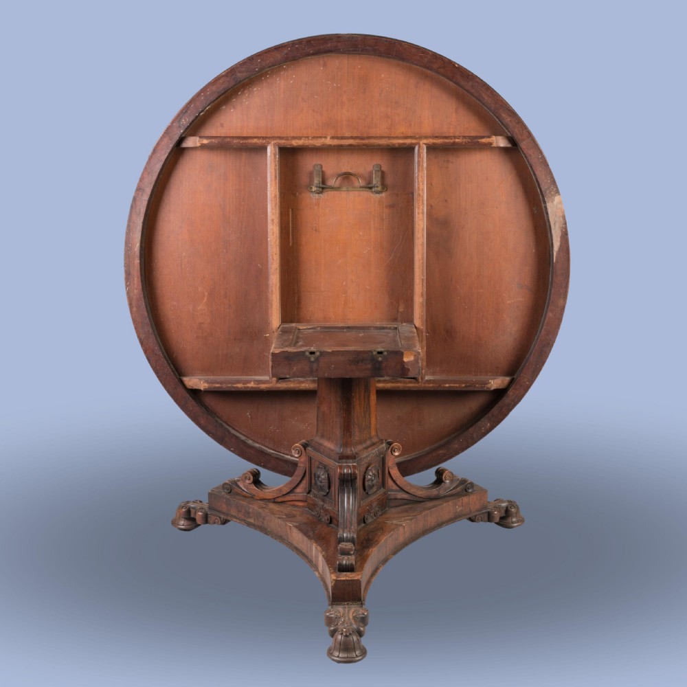 A circular 19th-century William IV centre table crafted from dark wood with a carved central pedestal and platform base with scroll feet. View III