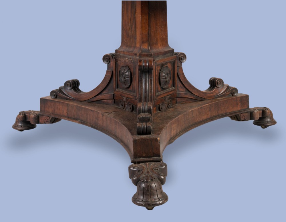 A circular 19th-century William IV centre table crafted from dark wood with a carved central pedestal and platform base with scroll feet. View IV