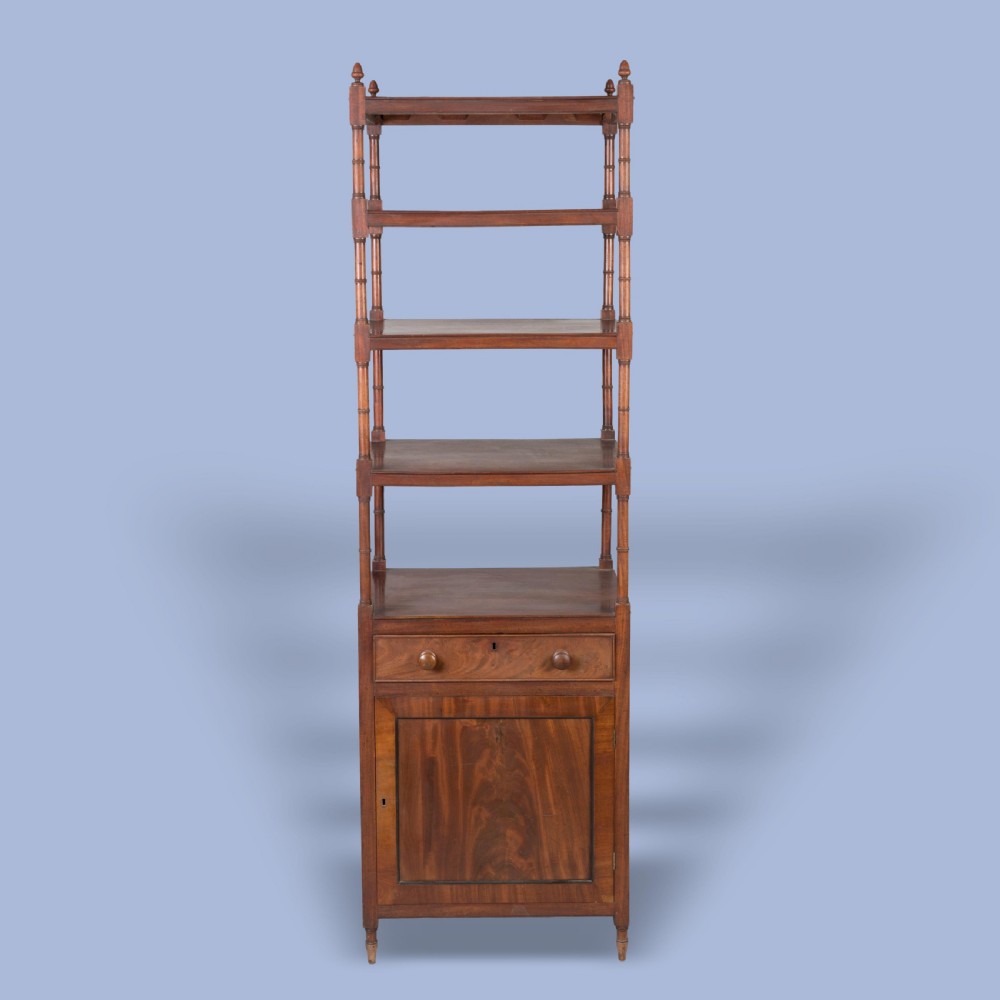 A tall George IV mahogany whatnot featuring four open tiers supported by turned columns above a single drawer and base cupboard. View II