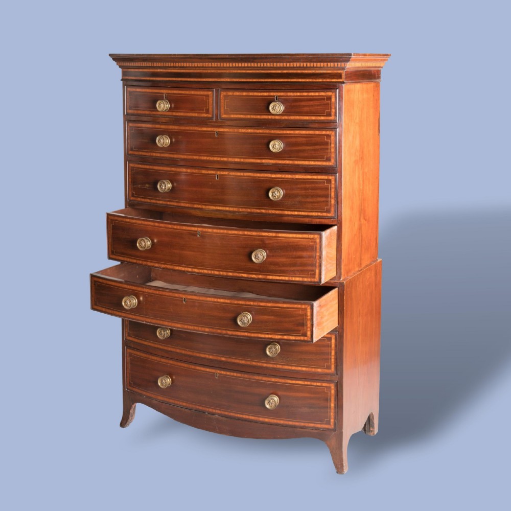 A George III bow-fronted mahogany tallboy chest-on-chest with brass pull handles and geometric line inlay. View III