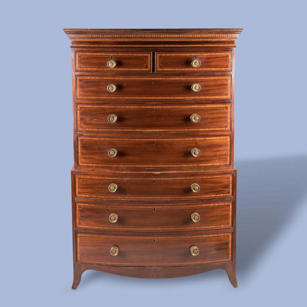 A George III bow-fronted mahogany tallboy chest-on-chest with brass pull handles and geometric line inlay. View V