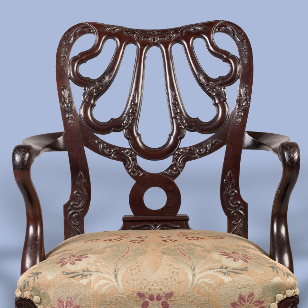 A dark mahogany open armchair featuring a carved pierced back splat, floral pattern upholstered seat, and cabriole front legs with ball-and-claw feet. View III
