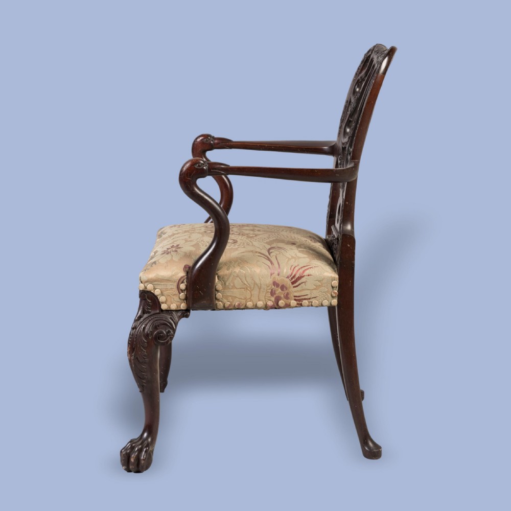 A dark mahogany open armchair featuring a carved pierced back splat, floral pattern upholstered seat, and cabriole front legs with ball-and-claw feet. View V
