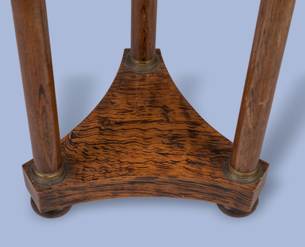 A pair of tall French Empire style mahogany pedestals featuring brass gallery rims, gadrooned tops, three cylindrical columns, and tri-form bases resting on bun feet. View III
