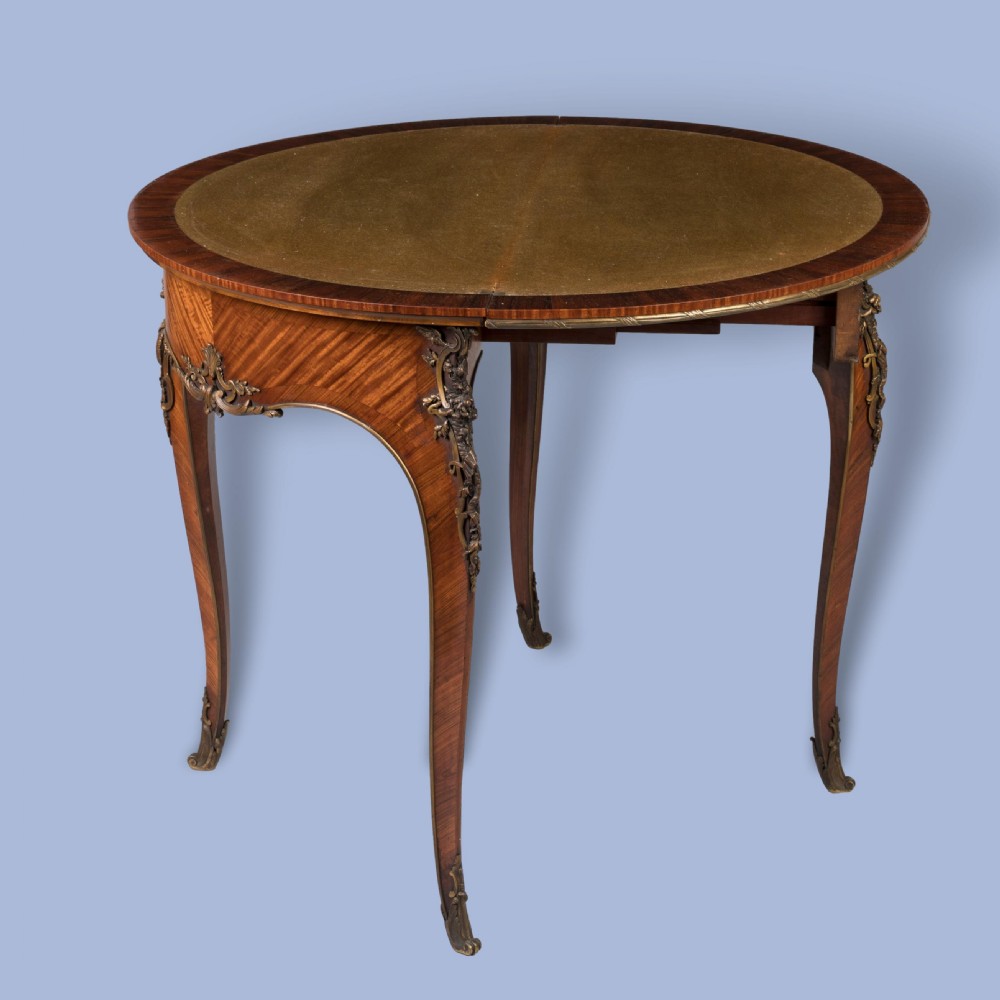 A French Louis XV style demilune kingwood card table featuring curved cabriole legs, intricate parquetry veneer, and decorative gilt-bronze mounts. View II