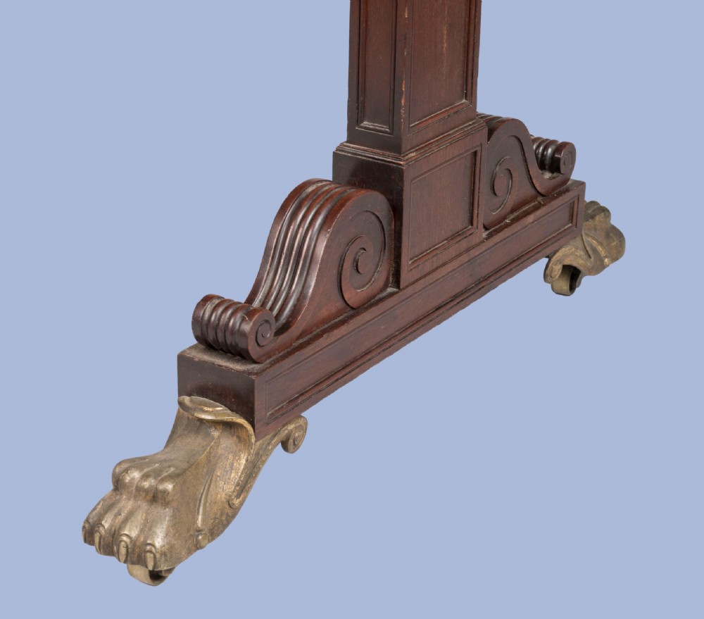 A Regency period dark mahogany sofa table featuring two frieze drawers, drop leaves, a turned stretcher, and splayed legs with brass paw feet. View IV