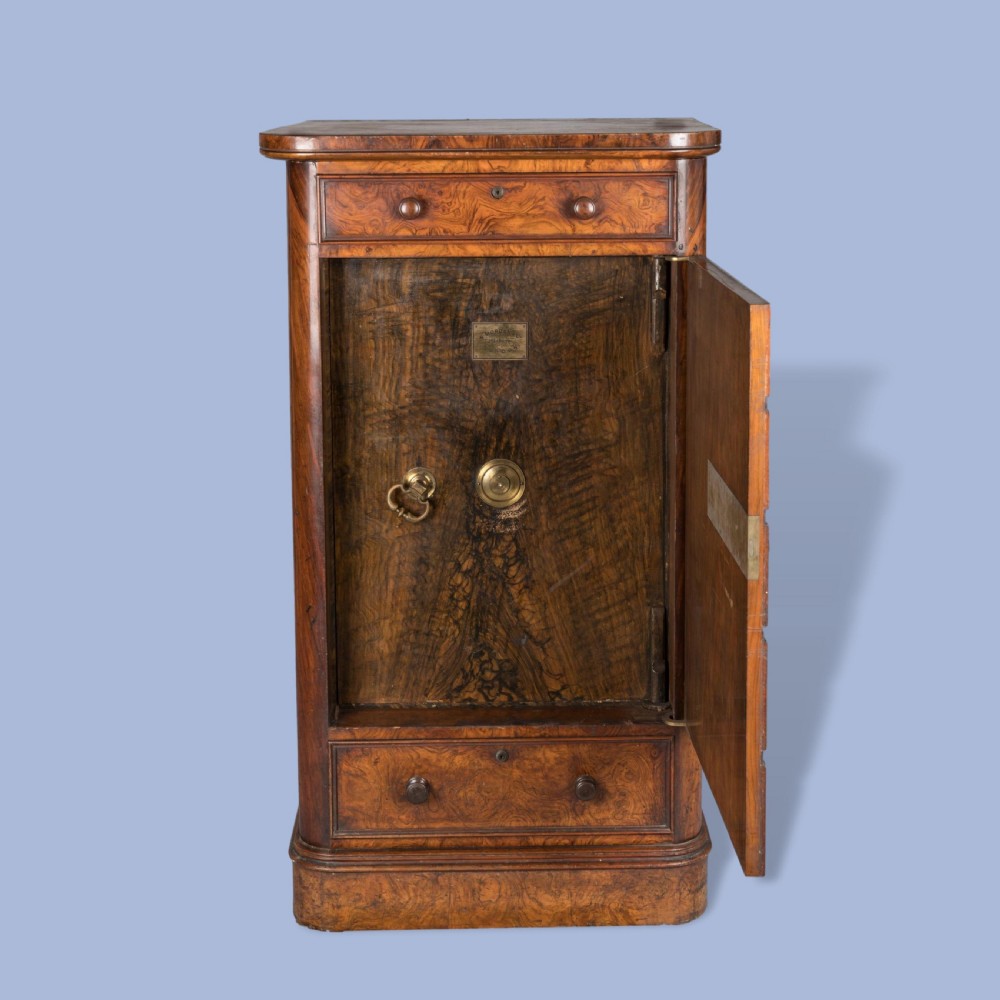 A tall Victorian burr walnut Wellington chest featuring seven graduated drawers, turned knobs, a locking side bar, and a plinth base. View II