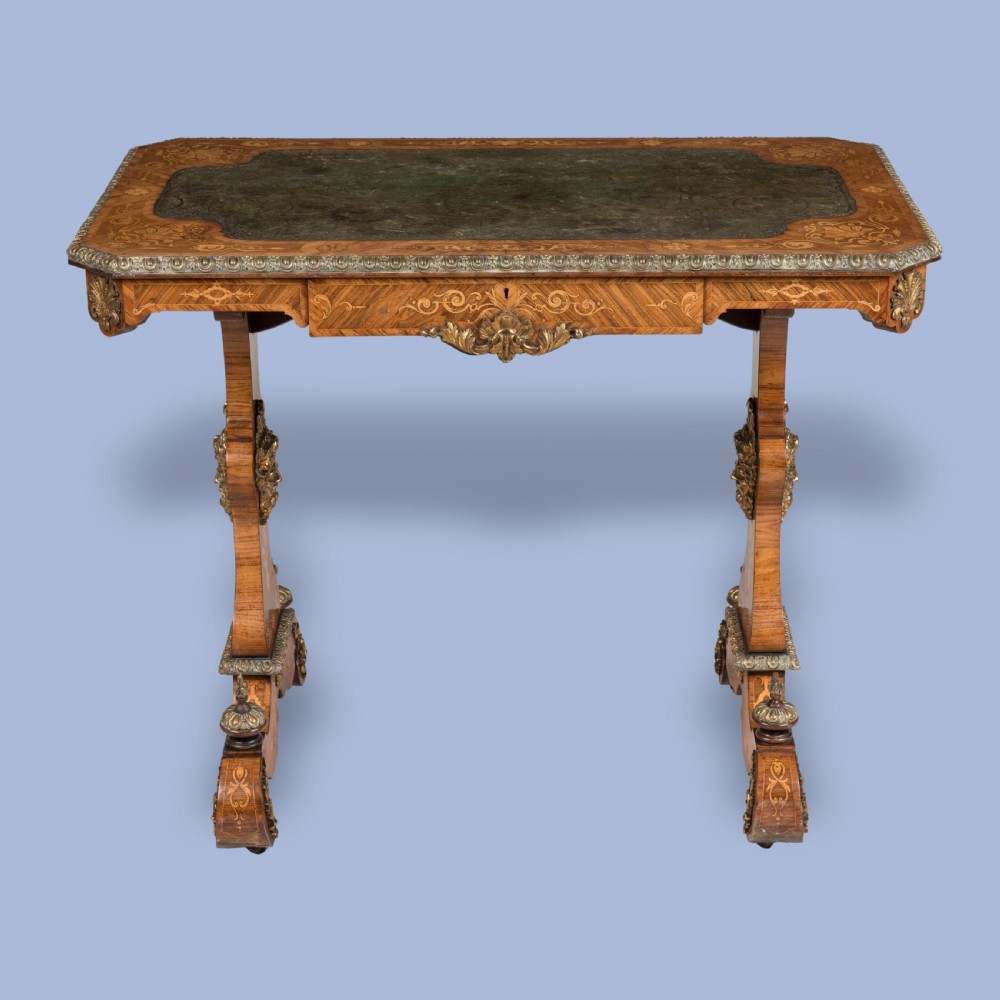 An ornate 19th-century French style marquetry writing table featuring a green leather top, gilt-bronze mounts, and scrolled end supports. View II