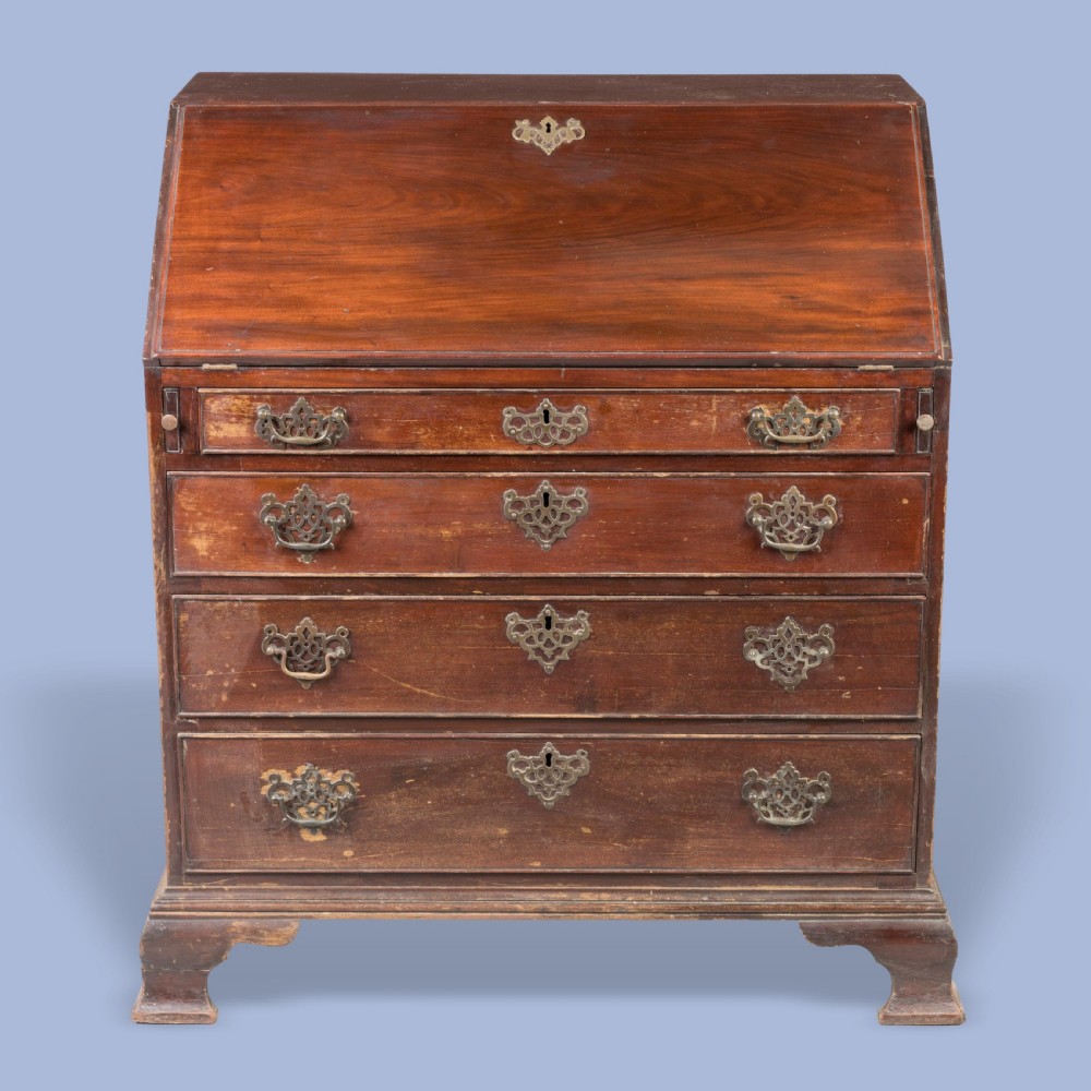 A Georgian mahogany slant-front writing bureau featuring four graduated drawers with decorative brass handles and bracket feet. View III