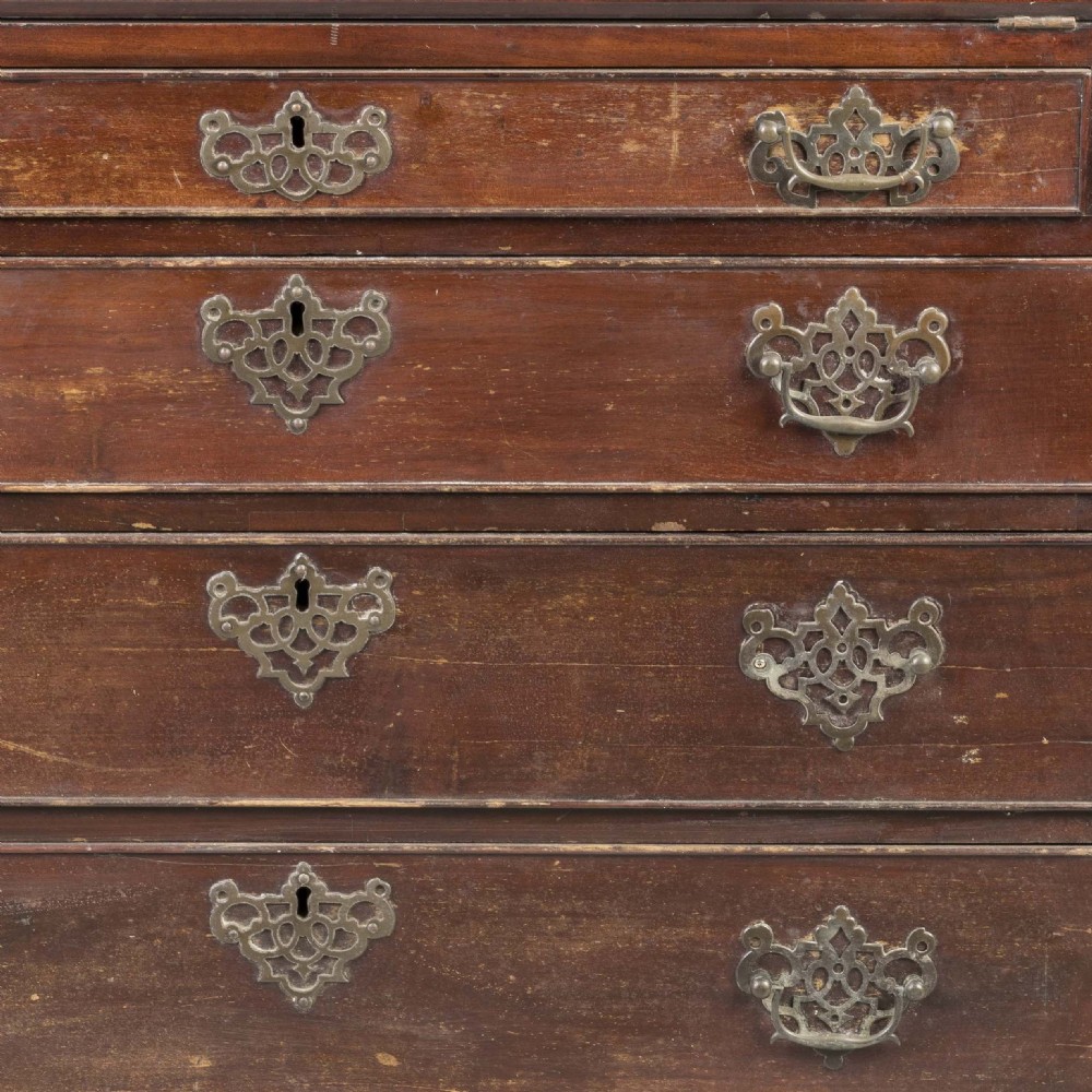 A Georgian mahogany slant-front writing bureau featuring four graduated drawers with decorative brass handles and bracket feet. View IV