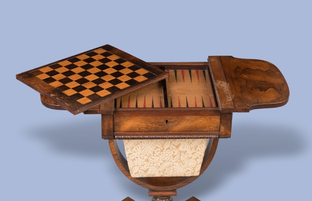 A William IV rosewood drop-leaf table with a fabric-covered work basket, U-shaped support, and carved claw feet. View V