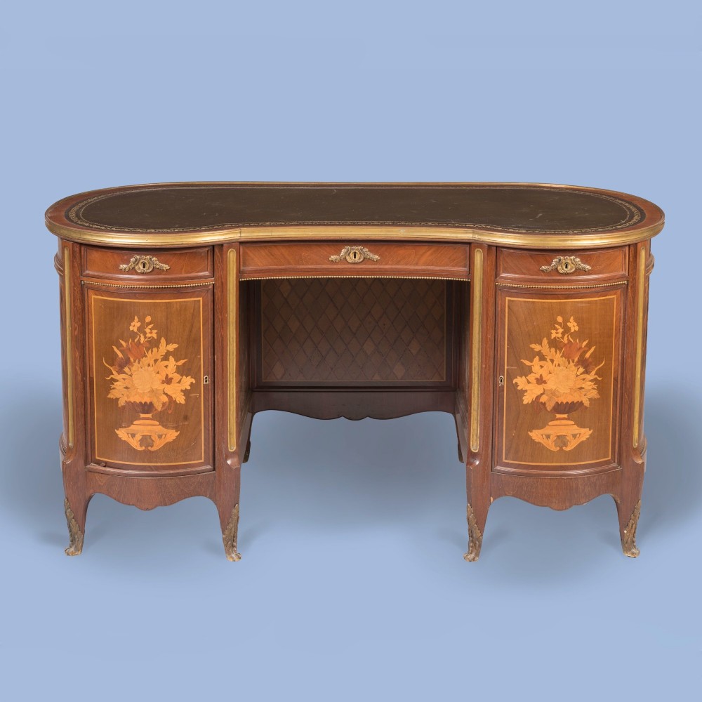 A kidney-shaped wooden writing desk featuring floral marquetry panels, gilt-bronze ormolu mounts, and a dark leather inset top with gold tooling. View II