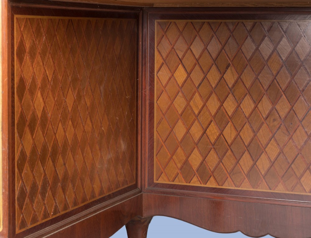 A kidney-shaped wooden writing desk featuring floral marquetry panels, gilt-bronze ormolu mounts, and a dark leather inset top with gold tooling. View VI