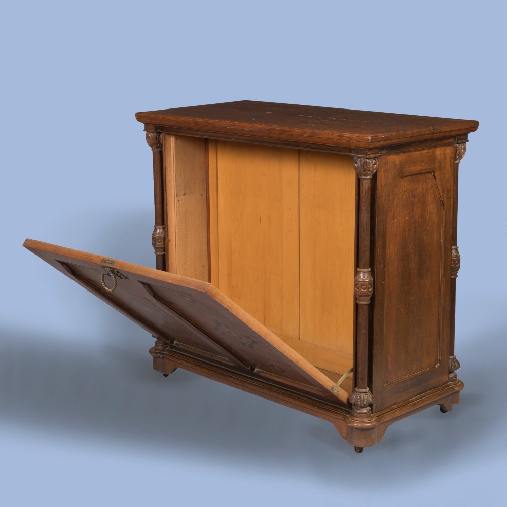 An antique Victorian Gothic Revival oak folio cabinet featuring geometric timber inlay on twin panel doors beneath an adjustable slatted display frame. View IV