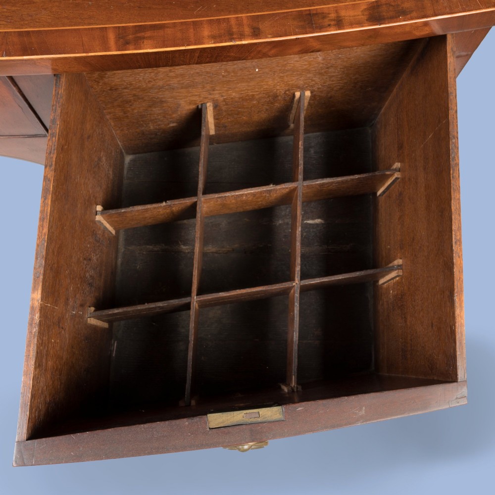 A Georgian Hepplewhite style flame mahogany sideboard featuring five drawers with brass ring handles, tapered square legs, and spade feet set against a light background. View III