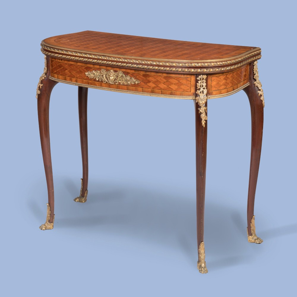 A French-style parquetry card table with cabriole legs and gilded bronze mounts on the apron and feet.