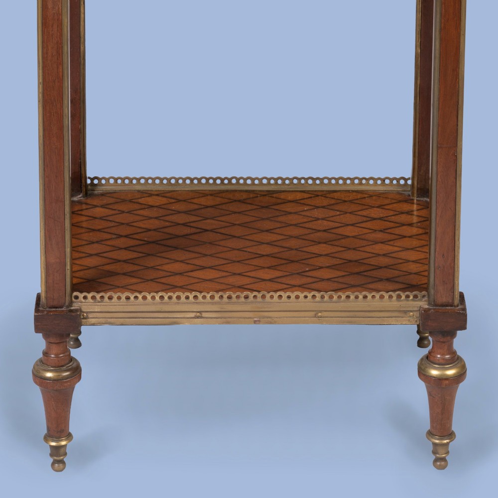 A three-tier rectangular wooden etagere featuring geometric parquetry shelves, pierced brass gallery rims, fluted corner supports, and brass-capped turned feet. View V