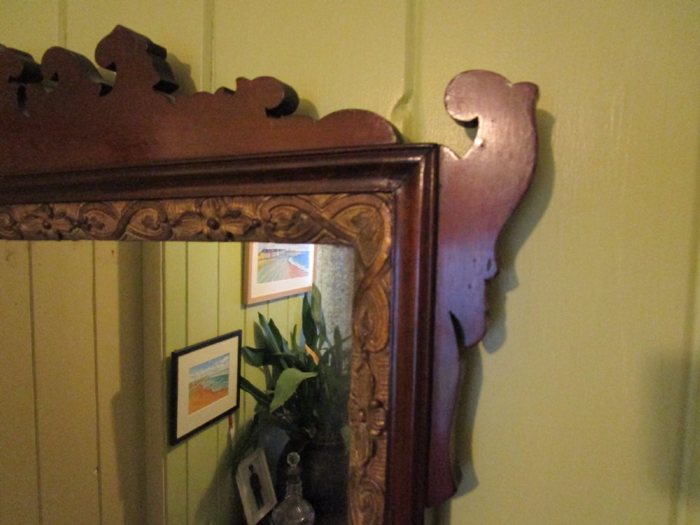 A rectangular mahogany wall mirror featuring decorative fretwork scroll cresting and an inner gilded floral slip. View III