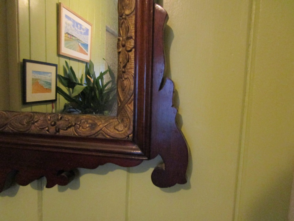 A rectangular mahogany wall mirror featuring decorative fretwork scroll cresting and an inner gilded floral slip. View IV