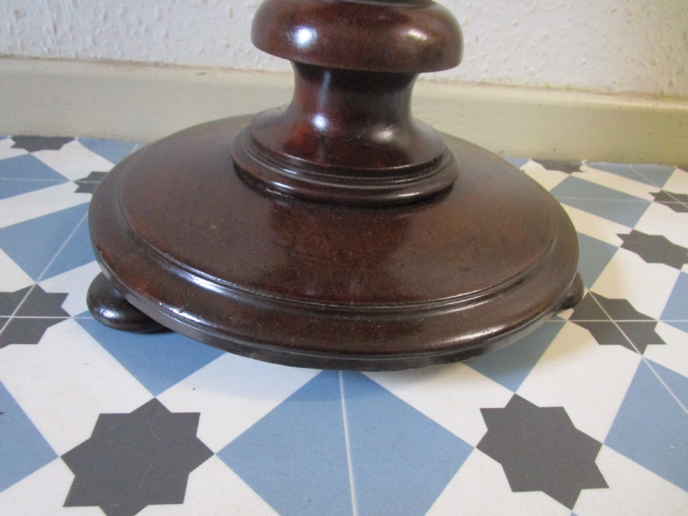 A Victorian dark wood revolving piano stool featuring a circular patterned velvet cushion trimmed with brass studs set atop a turned pedestal base. View II