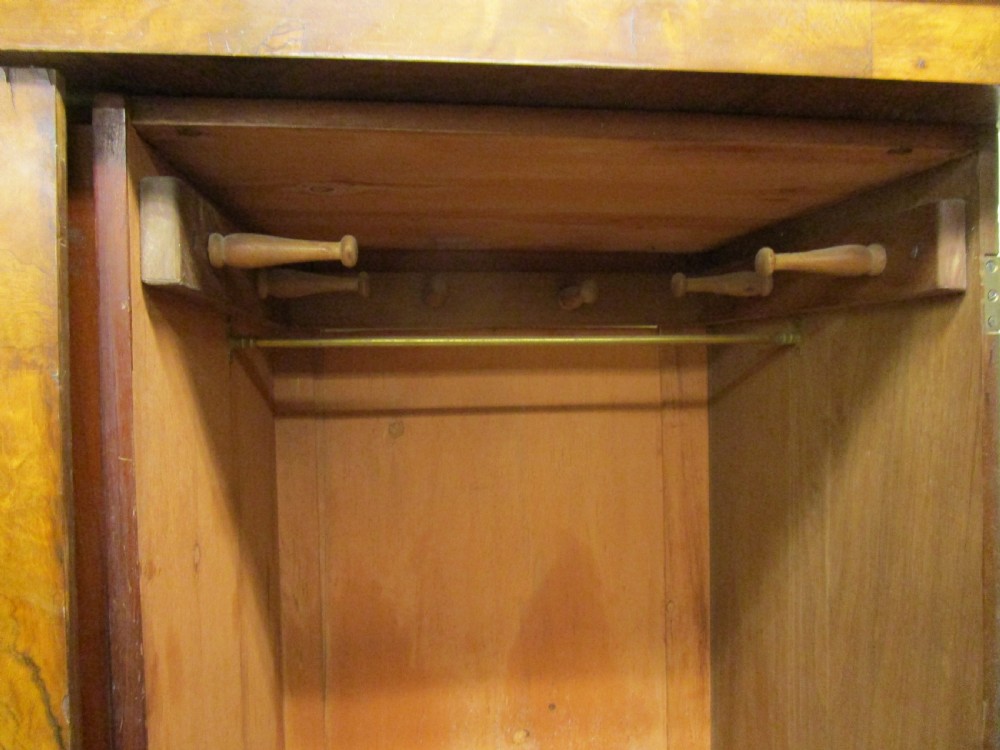 A Victorian three-door burr walnut compactum wardrobe featuring a full-length central mirror and arched panel doors set on a plinth base. View V