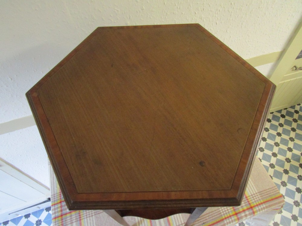 A warm brown mahogany occasional table featuring pierced fretwork side panels, a lower tier, and slender tapered legs. View IV