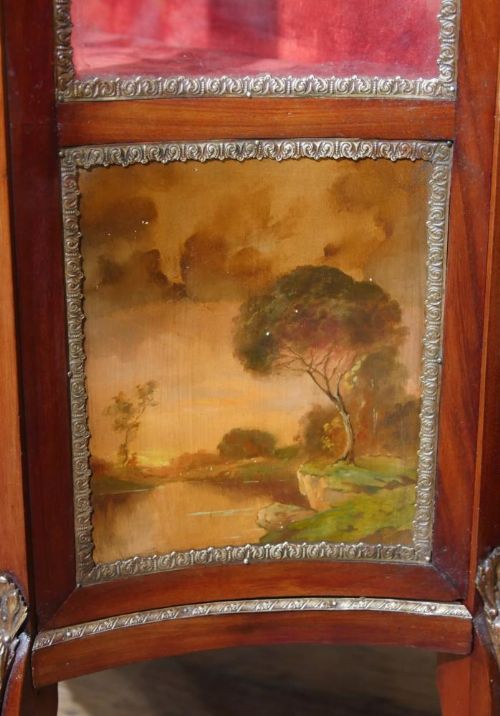 fig 2. A French Vernis Martin style display cabinet featuring a glass door, side glass panels, red velvet interior shelves, ormolu mounts, and a hand-painted lower panel on cabriole legs.