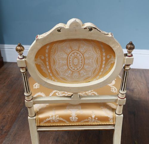 fig 1. A pair of French Neoclassical side chairs featuring painted off-white frames with fluted legs, oval medallion backs, and gold patterned silk upholstery.