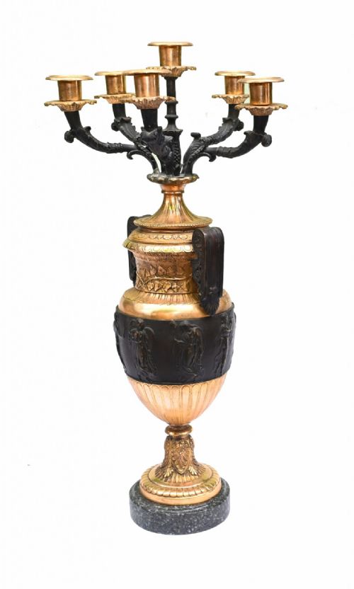 fig 1. A symmetrical pair of antique gilt and dark patinated bronze multi-branch candelabras shaped like Classical urns on grey marble bases.
